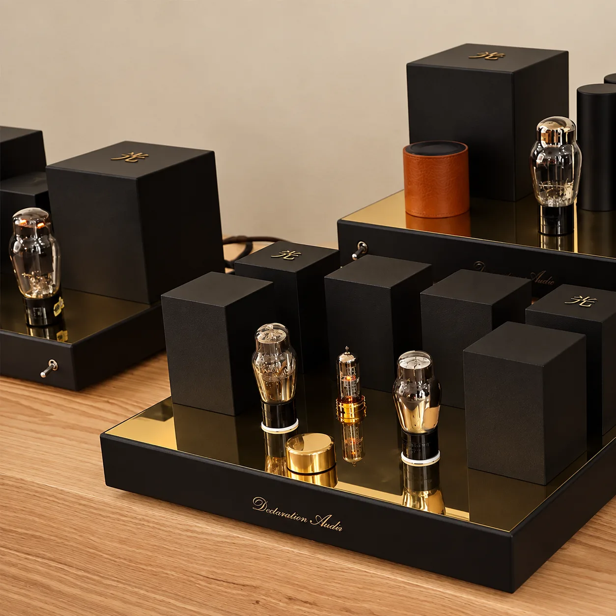 The Line Stage 76 preamplifier on light oak, black blocks and glass valves on a brass plate.