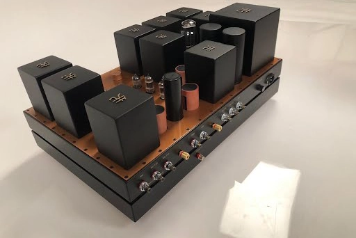 A Phono Stage amplifier on a base, featuring multiple black electronic components.