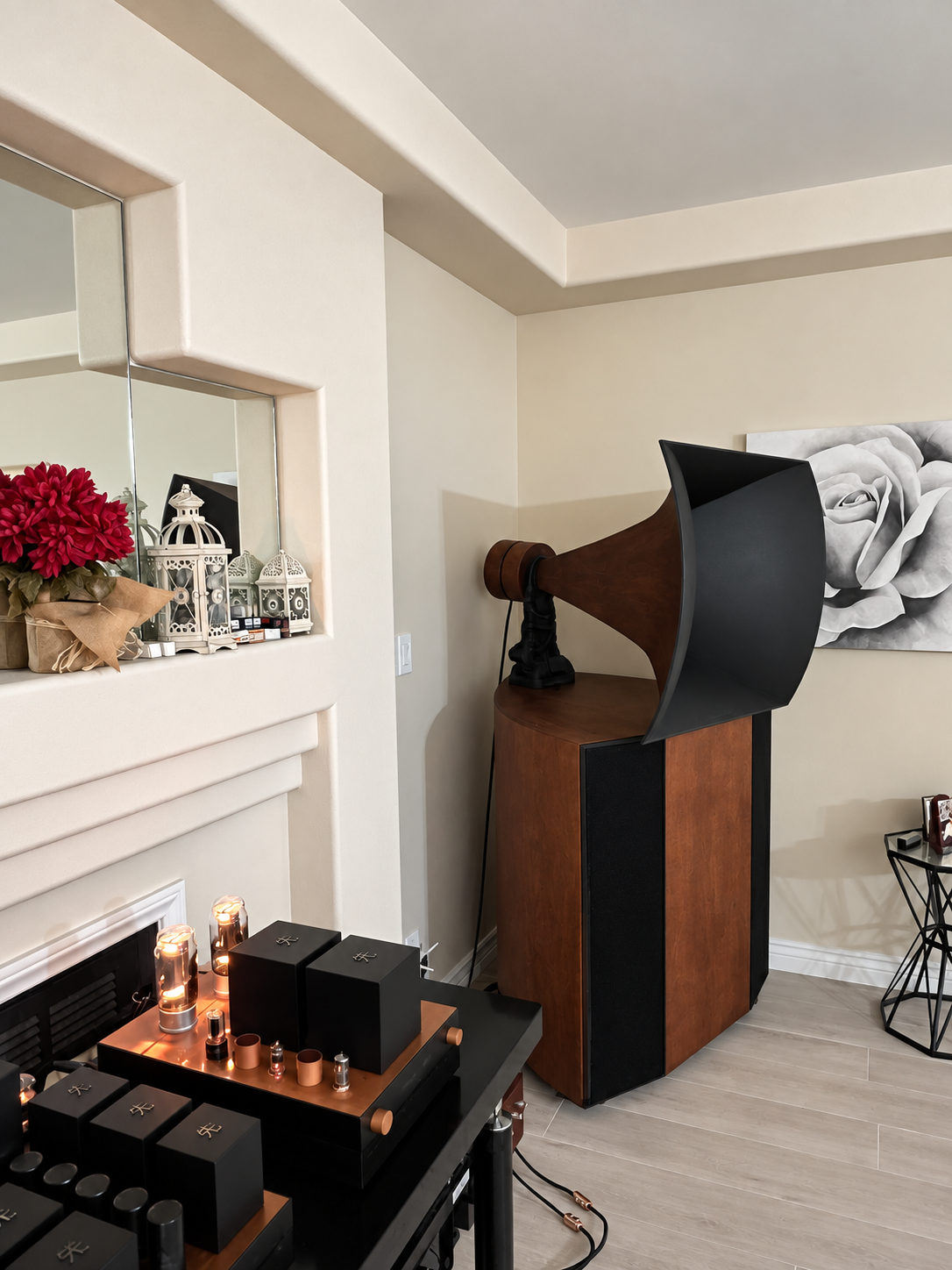 A Destination Audio Vista horn loudspeaker beside a fireplace.