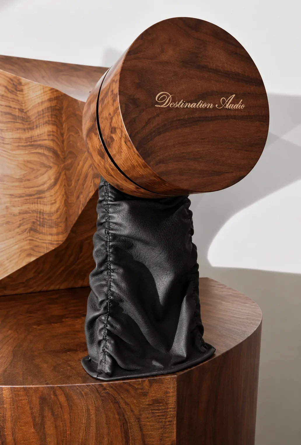 A walnut Destination Audio driver housing and horn assembly.