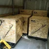 Three large wooden crates labeled "Vista 3-Way Horn Speakers" inside a shipping truck, arranged with a pallet jack nearby.