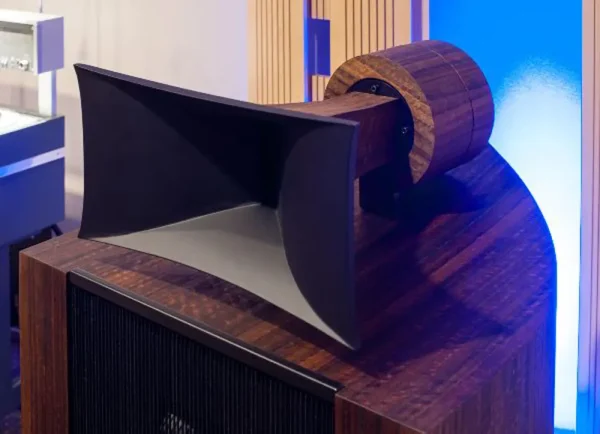 Modern, abstract wooden desk design with curved shapes and contrasting textures, featuring Vista 3-Way Horn Speakers on top.