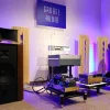 High-end audio equipment from Destination Audio displayed in a room with purple lighting, including Vista 3-Way Horn Speakers and various amplifiers.