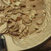 Wood shavings on a carved wooden surface with a carving tool and Vista 3-Way Horn Speakers visible in the foreground.
