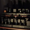 A collection of vintage tube amplifiers, including several Vista 3-Way Horn Speakers, with glowing tubes on a wooden shelf, displayed in a dimly lit room.