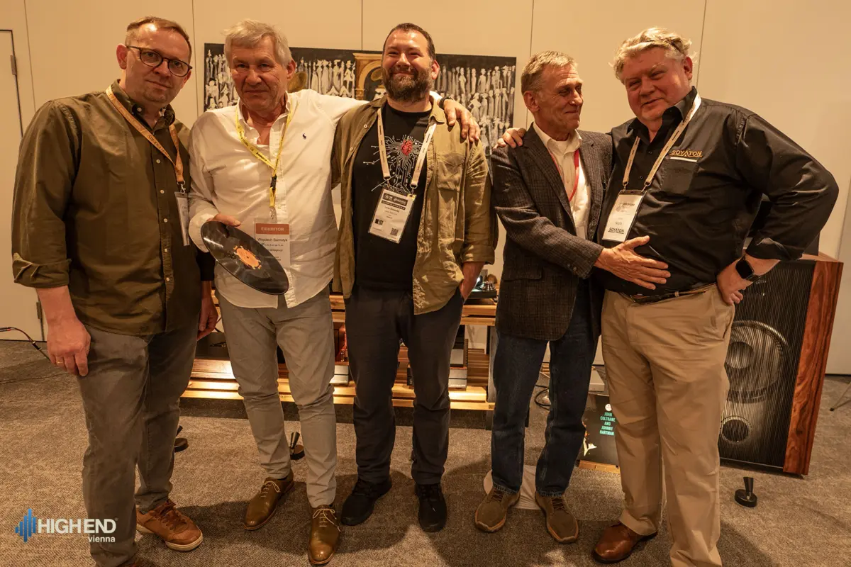Five men at the Destination Audio room at High End Vienna 2026, one holding a vinyl record