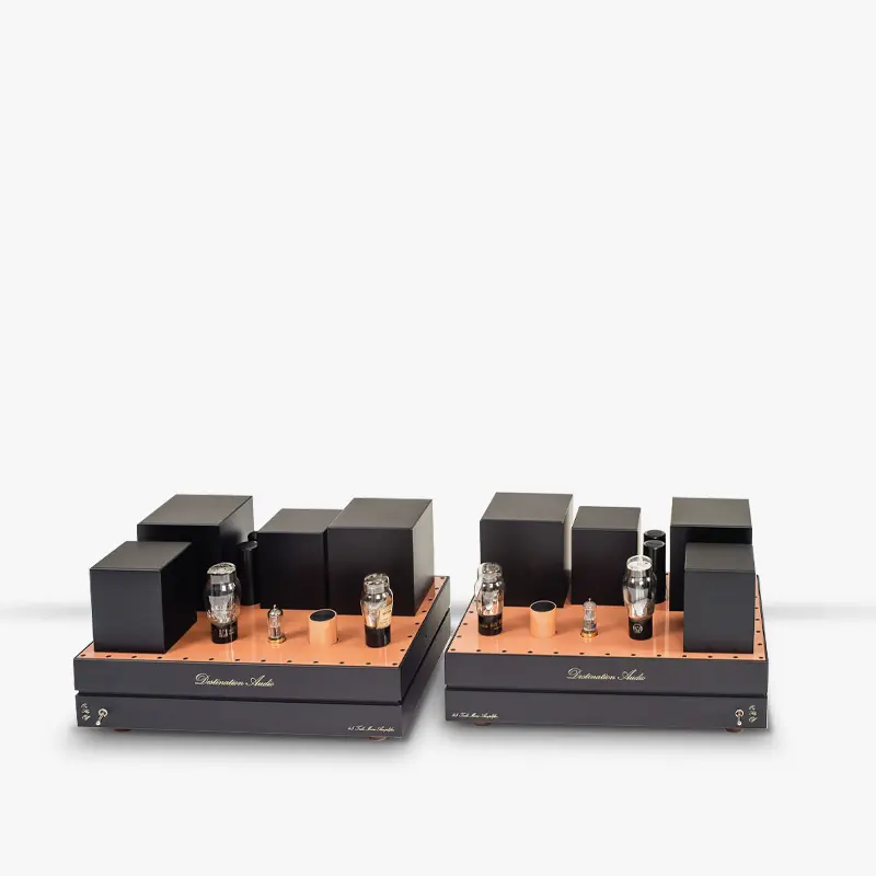 A pair of Destination Audio 45 tube mono amplifiers with tubes on copper-colored top plates