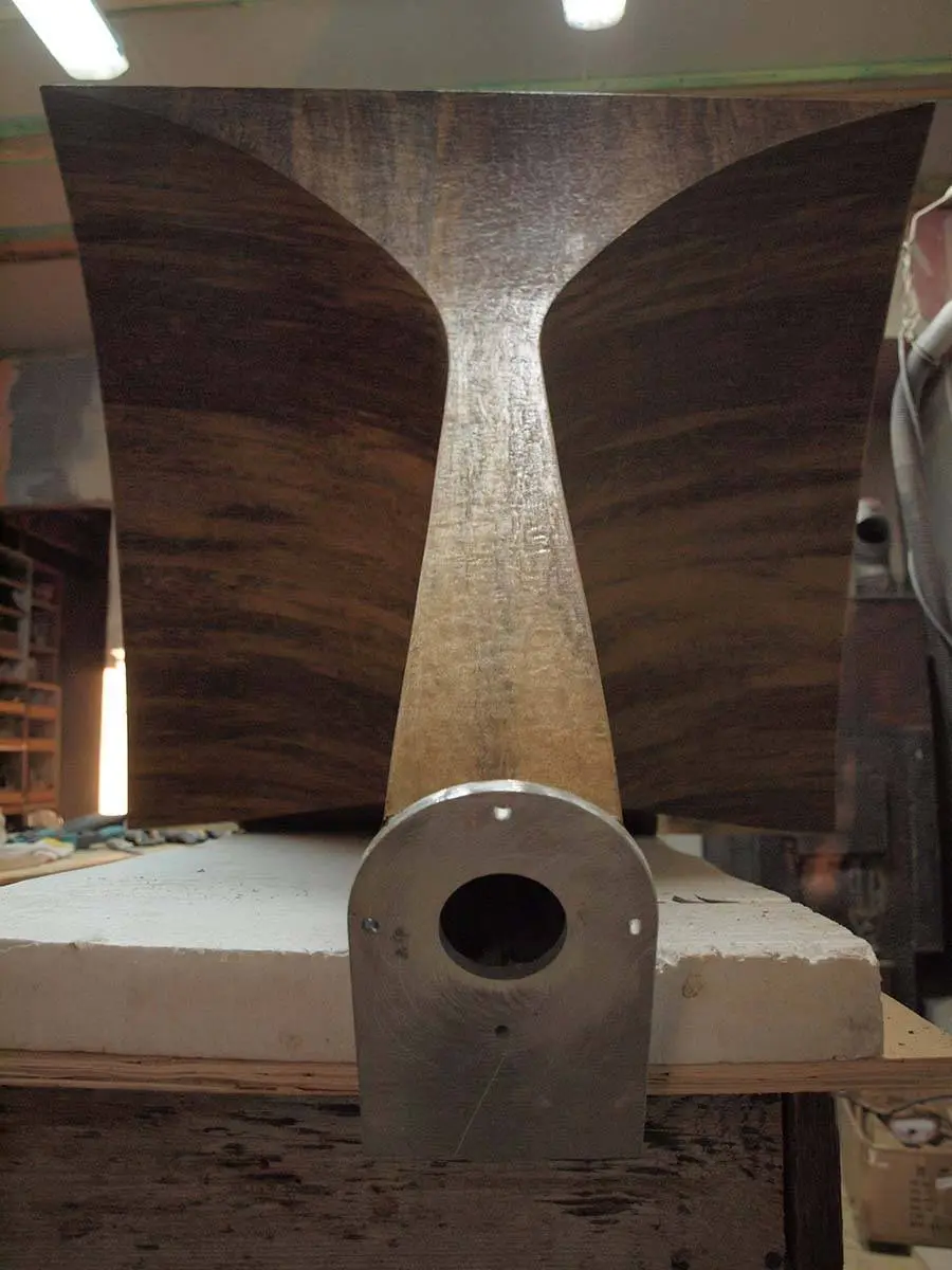 Rear of a wooden horn flare on a workbench with an aluminium mounting block